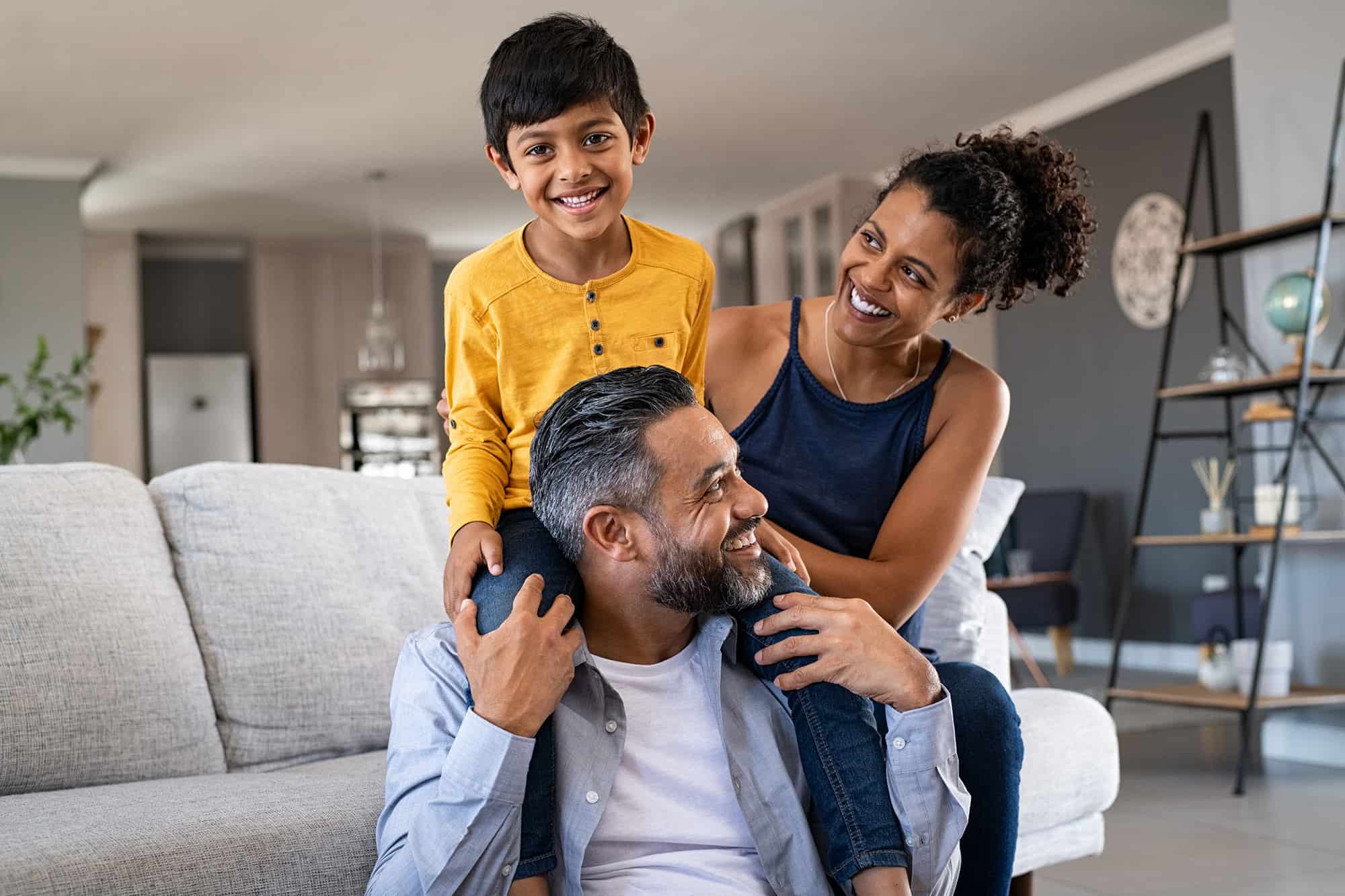 Young family snuggling in living room