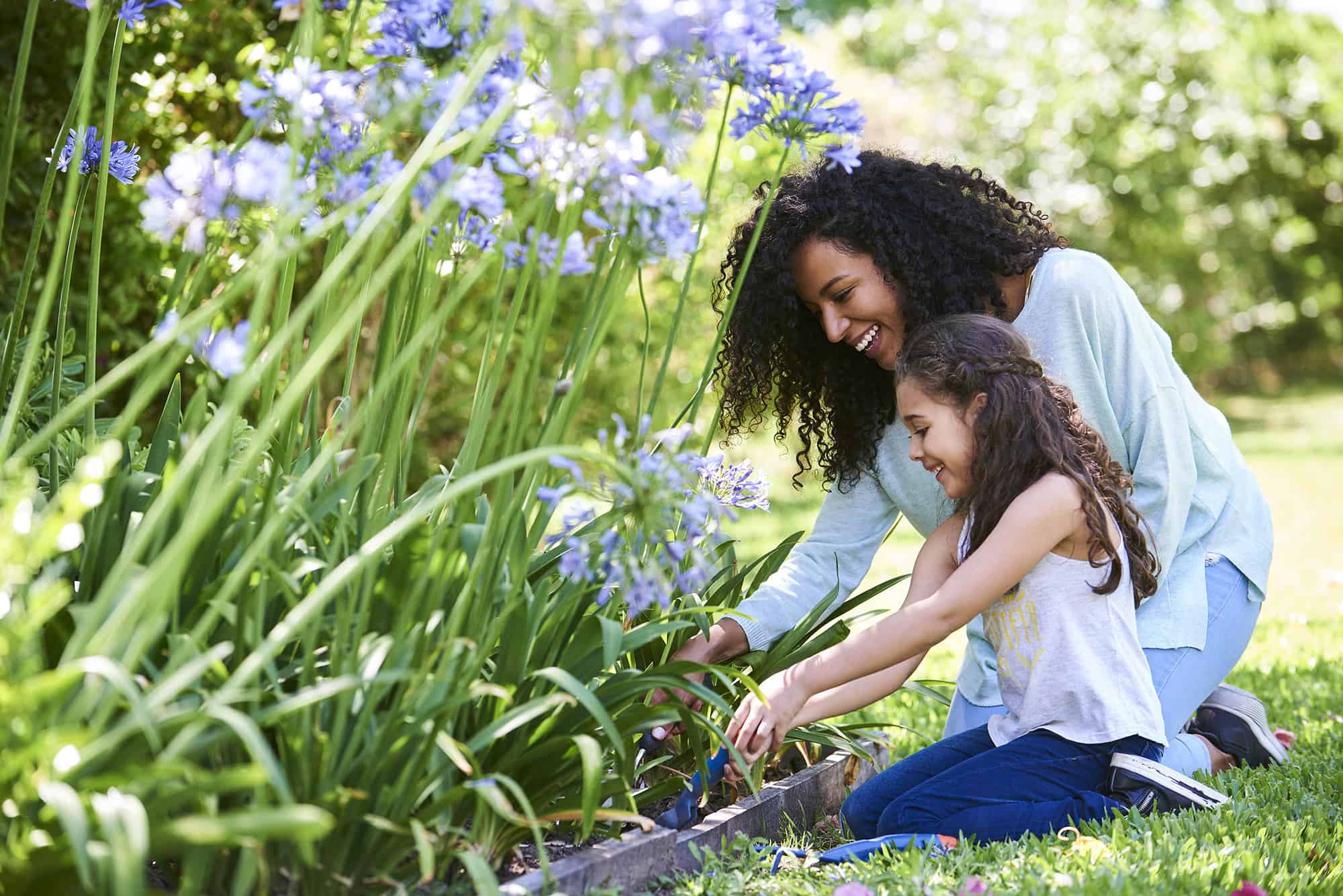 Mother and young daughter gardening
