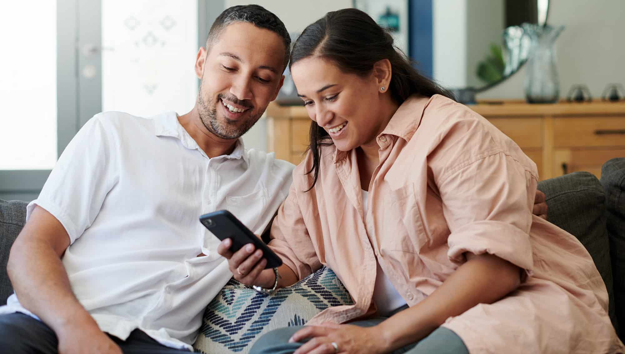 Couple on couch with cell phone