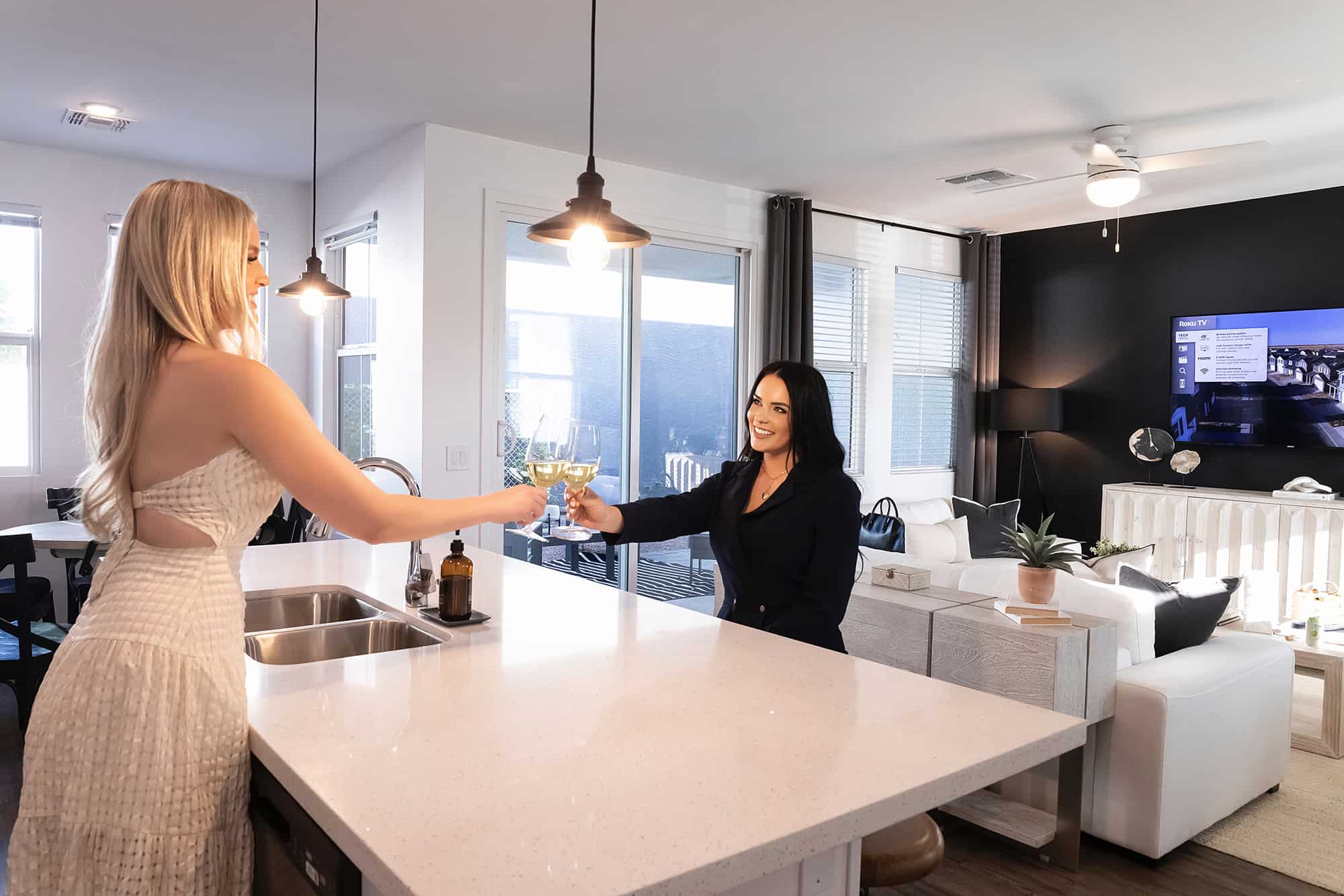 women with wine at kitchen island